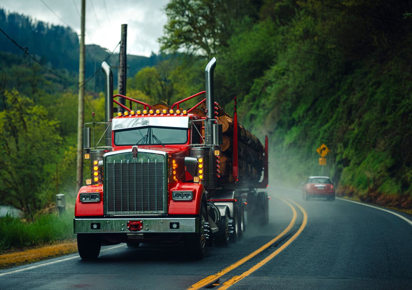 A semi truck hauling a load on a mountain highway, representing route-based matching on Truckers Dating